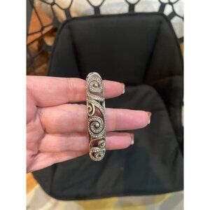 This is a Brighton Anahita silver-plated scrolled hinged bangle bracelet with Sw